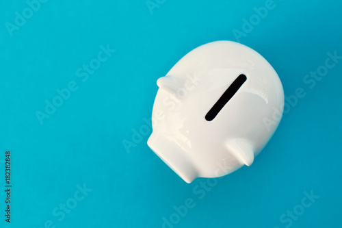 White piggy bank on blue background concept save money