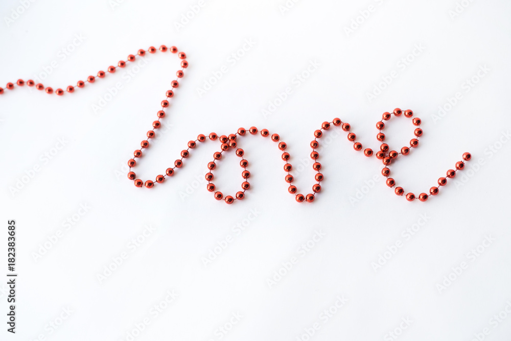 The word LOVE - declaration of written with red beads isolated on white background The word LOVE - declaration of written with red beads isolated on white background