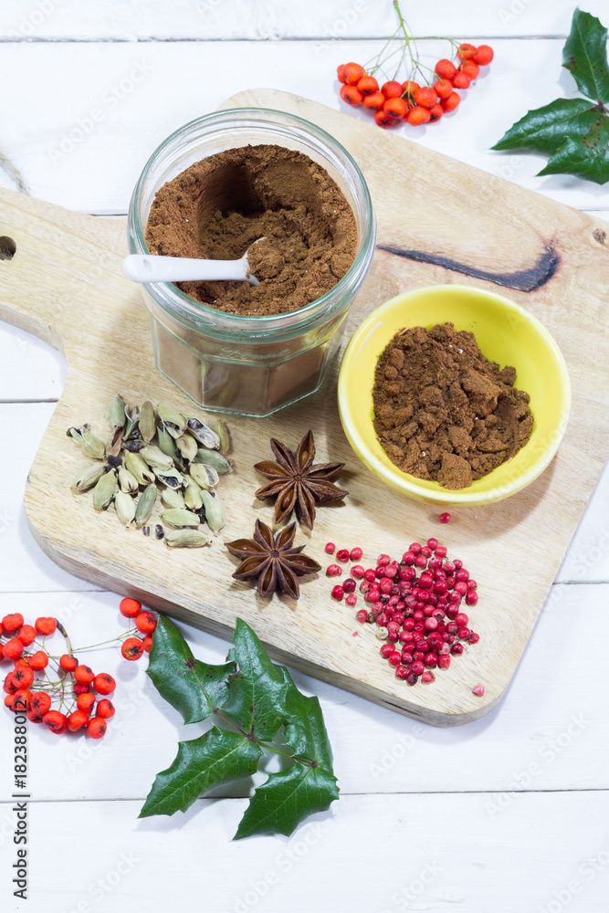 Gingerbread spices in the jar. White, wooden table. Wooden kitchen board. Gingerbread spices in the jar. White, wooden table. Wooden kitchen board.