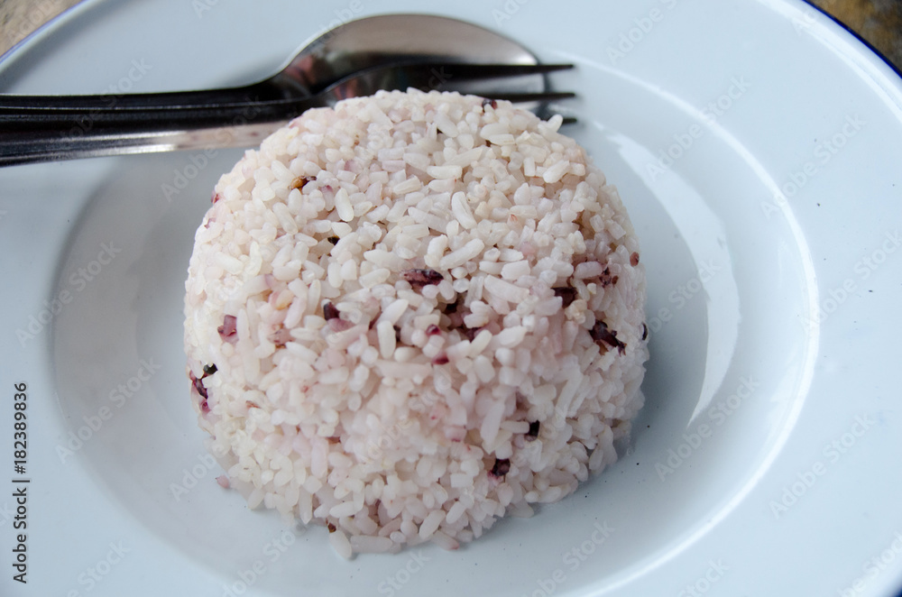 Steamed rice with chopsticks on wooden table Steamed rice with chopsticks on wooden table