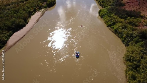 Aerial of people floating down the colorado river in a dry utah desert