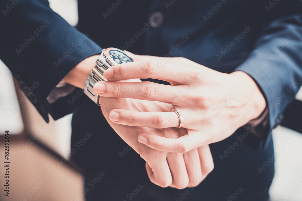 Businessman looking at his watch in office. concept for business Businessman looking at his watch in office. concept for business