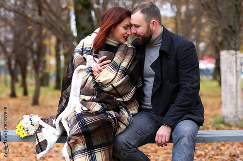 A pair of young people meets in autumn