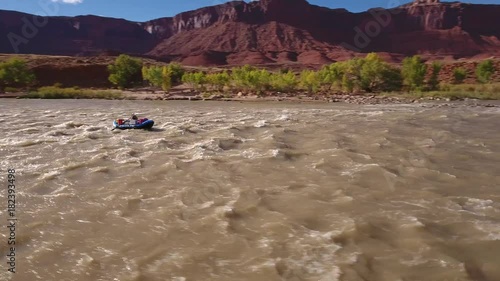 Aerial people float down the colorado river in the dry desert