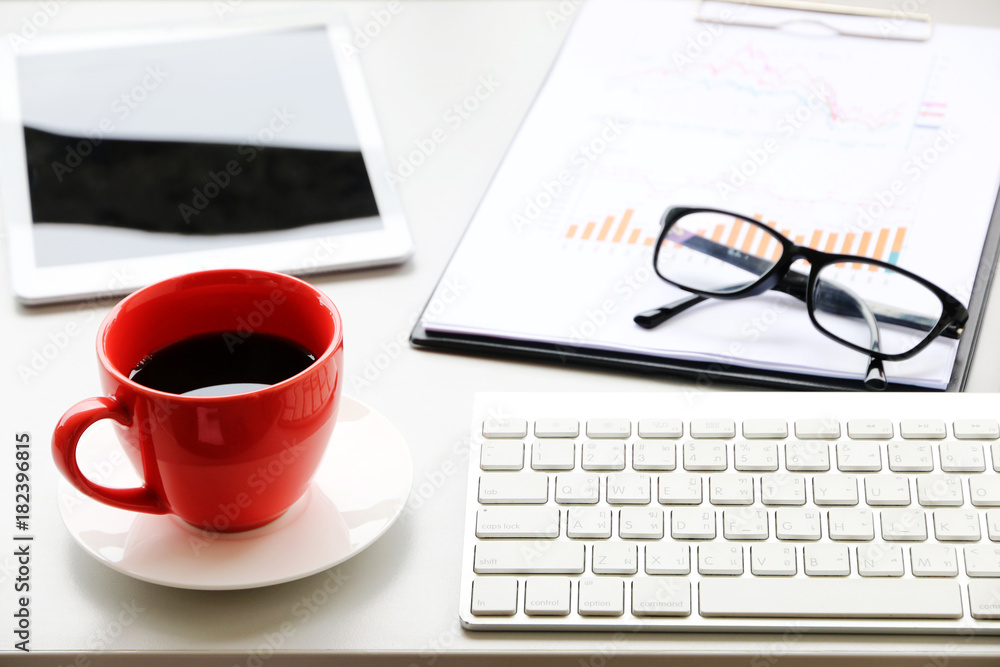 Red Coffee Cup on the desk Business Workspace background in Office Morning work.business concept Red Coffee Cup on the desk Business Workspace background in Office Morning work.business concept
