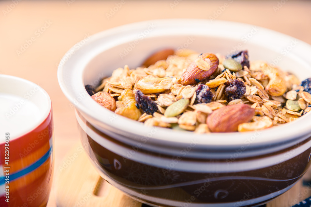 closed up of multi-grain cereal with dried fruits and nuts in an asian style bowl closed up of multi-grain cereal with dried fruits and nuts in an asian style bowl