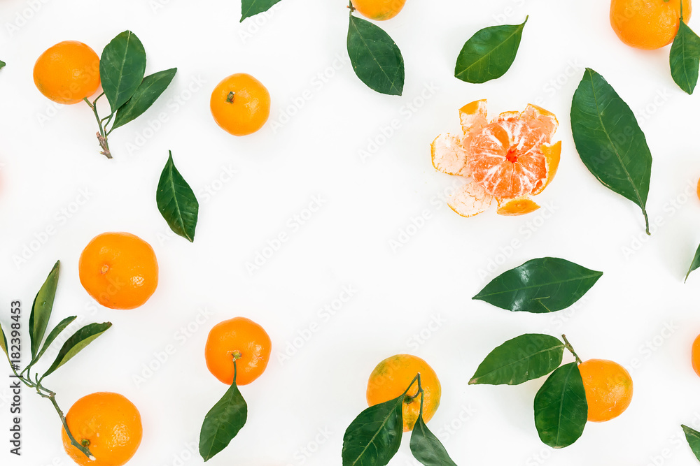 Frame made of fresh mandarin citrus and leaves on white background. Flat lay. Top view Frame made of fresh mandarin citrus and leaves on white background. Flat lay. Top view