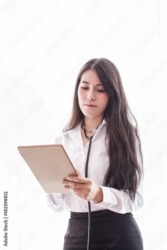 Woman doctor standing looking using digital tablet on white background.Selective Focus Woman doctor standing looking using digital tablet on white background.Selective Focus