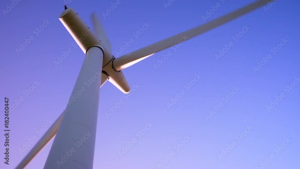 Single wind turbine on a bright blue sky day in strong winds Single wind turbine on a bright blue sky day in strong winds