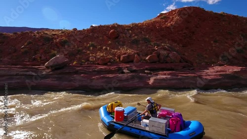 Aerial person floating down the colorado river in the dry desert