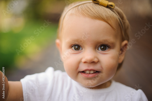 Slika na platnu Portrait of cute little blonde and brown-eyed girl