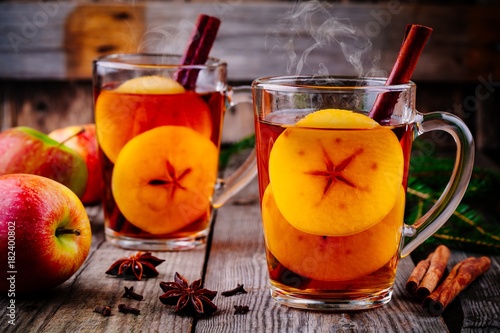 homemade hot mulled apple cider with a cinnamon stick photo