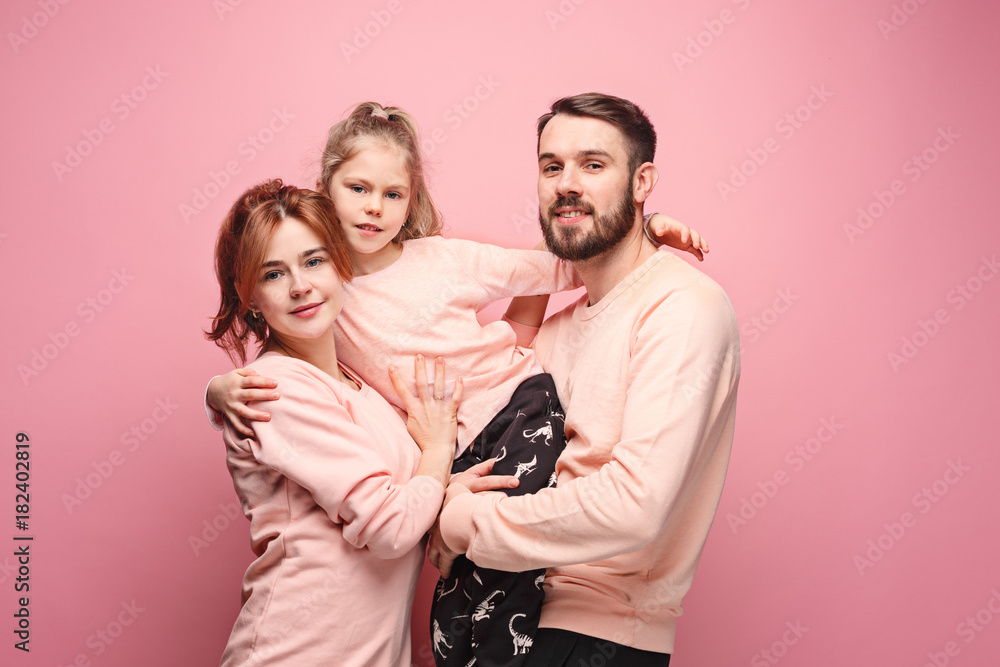 Happy young family with one little daughter posing together - obrazy, fototapety, plakaty 