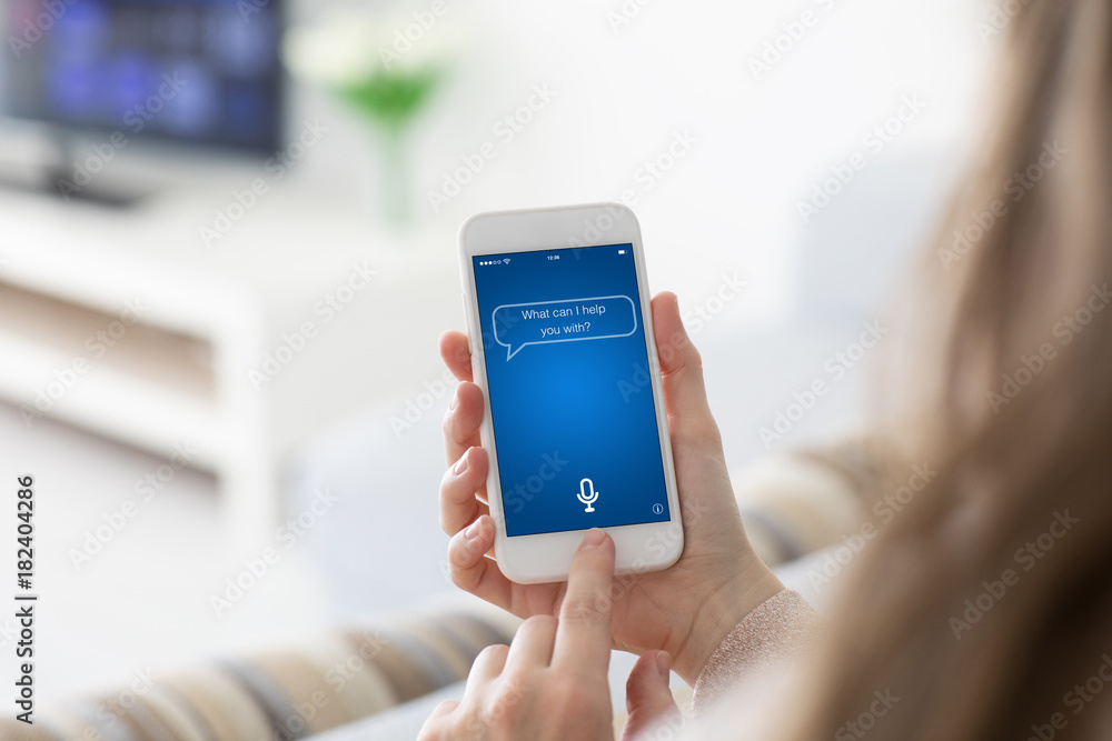 Female hands holding phone with app personal assistant on screen Female hands holding phone with app personal assistant on screen