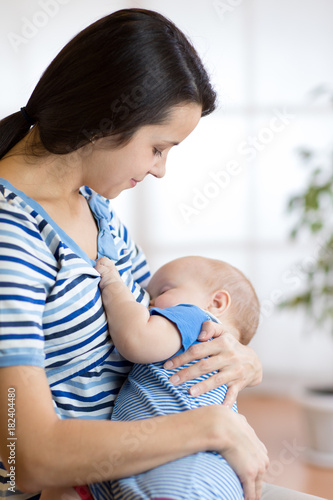 Baby feeds on mother's brea...