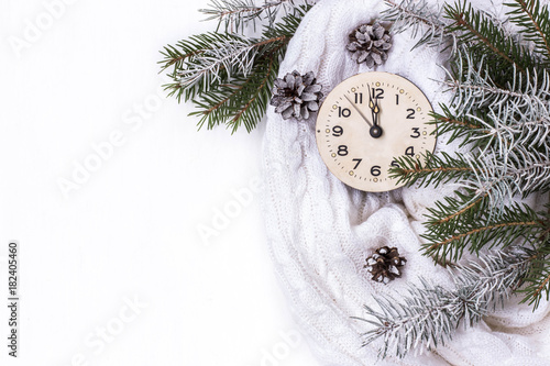white background with new year's clock, with branches of spruce, snow and cones