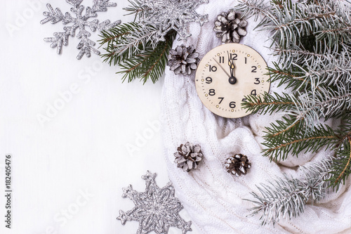 white background with new year's clock, with branches of spruce, snow and cones