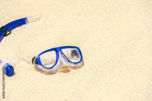 Diving mask and snorkel on sand beach