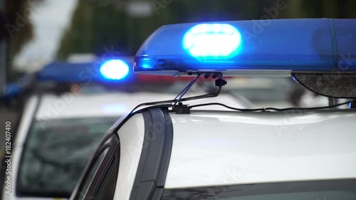 Shining flasher police car standing on the street in the city. Crime scene. Close up