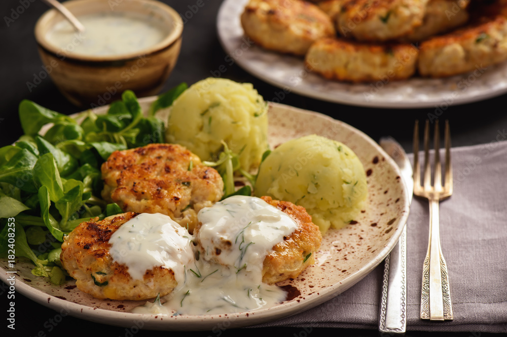 Chicken cutlets served with salad and garlic dip. Chicken cutlets served with salad and garlic dip.