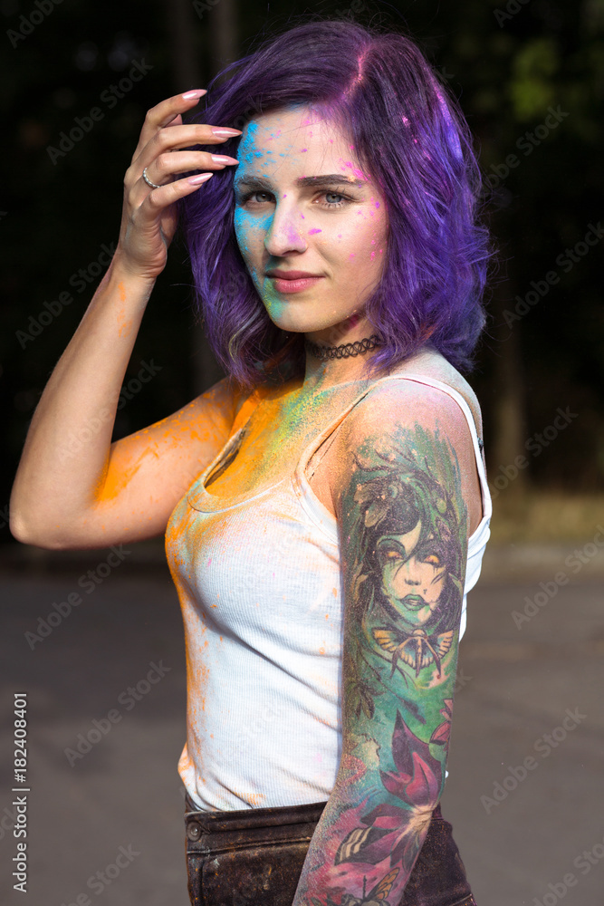 Beautiful woman with purple hair and tattoo on her arm covered with  colorful Holi powder Stock Photo | Adobe Stock