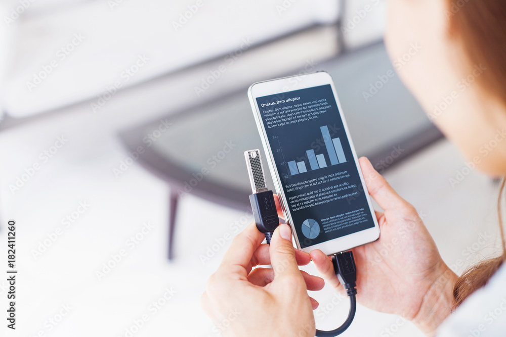 woman using otg usb with her mobile phone to see graphs woman using otg usb with her mobile phone to see graphs