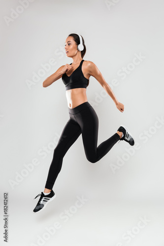 Full length portrait of a confident asian fitness woman