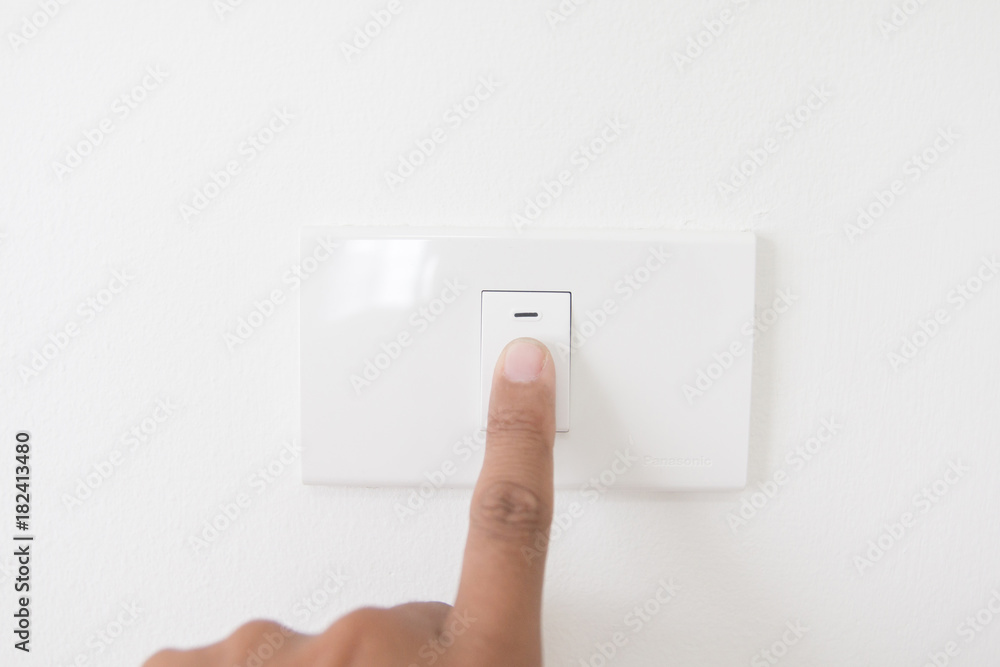 Closeup hand turn off a power button,Finger press light button,Hand with Power plug,interior electric power button in home,Concept switch on light Closeup hand turn off a power button,Finger press light button,Hand with Power plug,interior electric power button in home,Concept switch on light