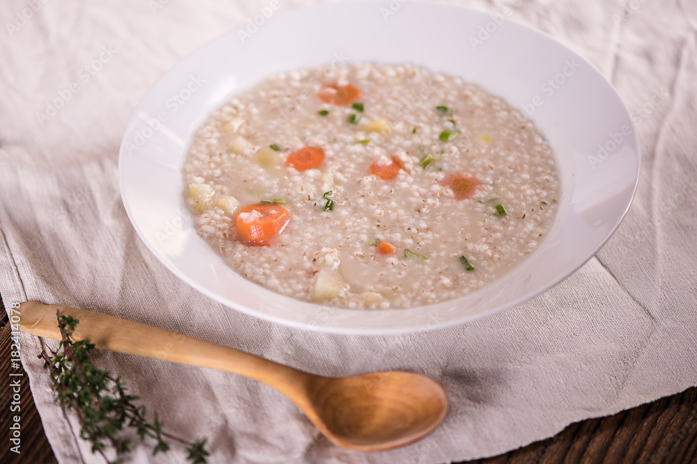 close up of a healthy taste barley soup with root vegetables