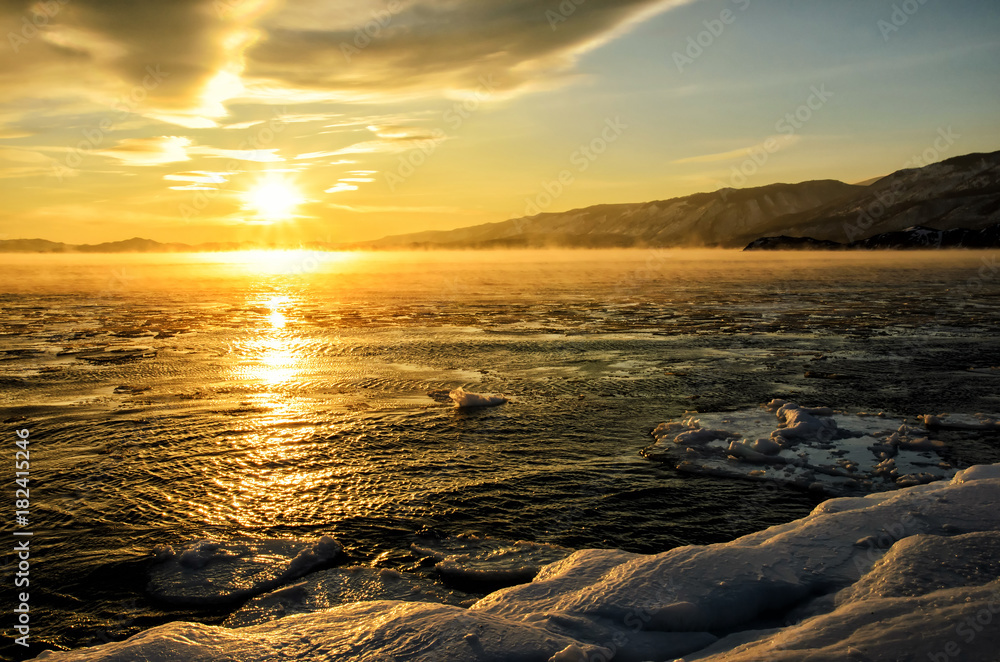Ice floes floating on the fog water in the lake Baikal. Sunset Ice floes floating on the fog water in the lake Baikal. Sunset