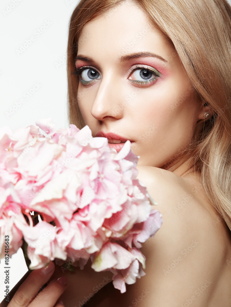 Closeup portrait of young beauty female face with blond hair and hydrangea bouquet flowers Closeup portrait of young beauty female face with blond hair and hydrangea bouquet flowers