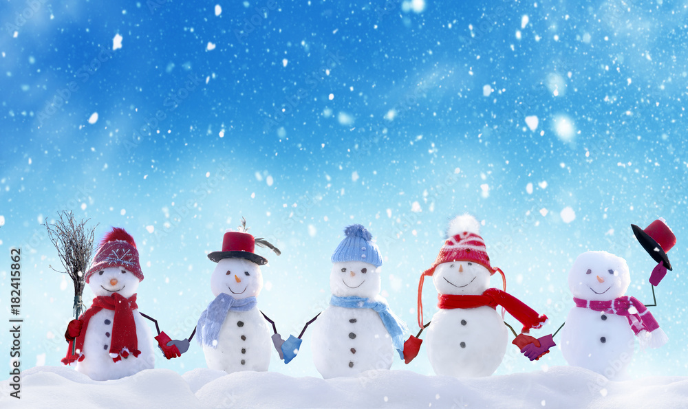 Plakat Merry Christmas and happy New Year greeting card with copy-space.Many snowmen standing in winter Christmas landscape.Winter background