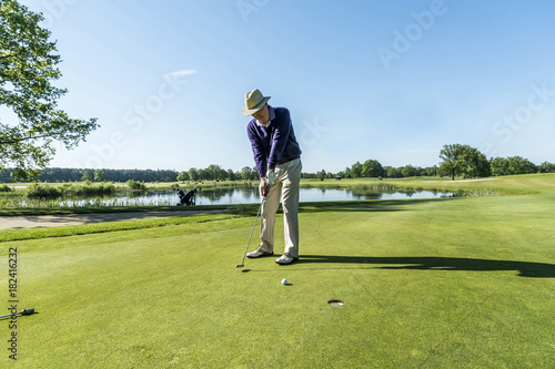 Senior man playing golf at a golf course