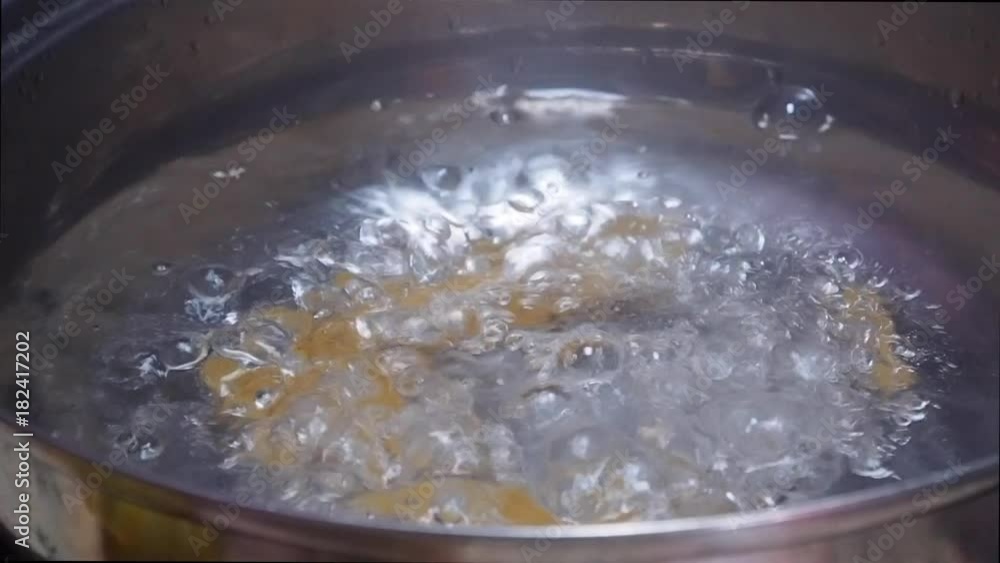 throwing pasta (penne) in boiling water throwing pasta (penne) in boiling water