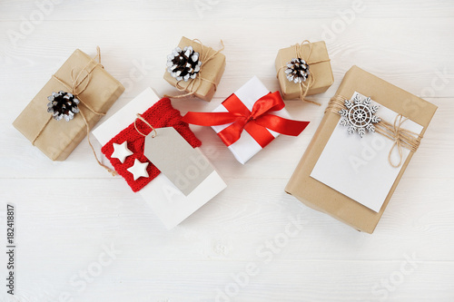 Mockup christmas background with decorations and red gift boxes on wooden board. Flat lay, top view photo mock up