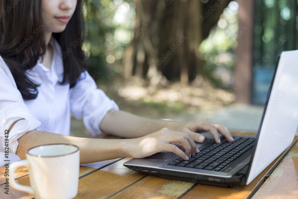 young woman working outdoors using notebook computer young woman working outdoors using notebook computer