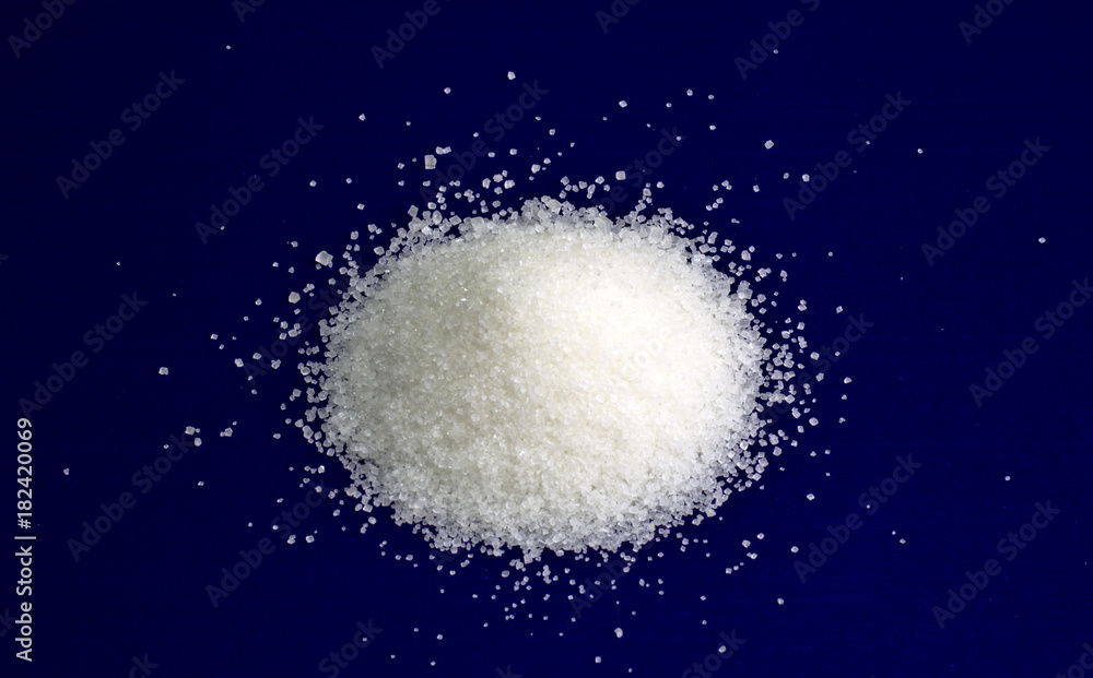Sugar. White refined sugar on a blue background. Sugar. White refined sugar on a blue background.