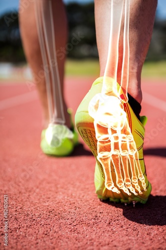 Fotografie Highlighted foot bones of jogging man