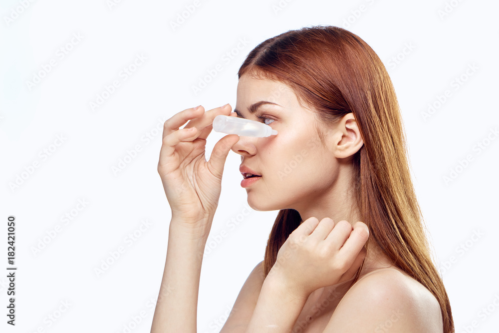 Young beautiful woman on white isolated background burying her eyes, portrait, space for copy Young beautiful woman on white isolated background burying her eyes, portrait, space for copy