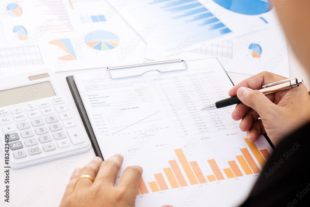marketing performance analyst working with sale report on a office desk marketing performance analyst working with sale report on a office desk