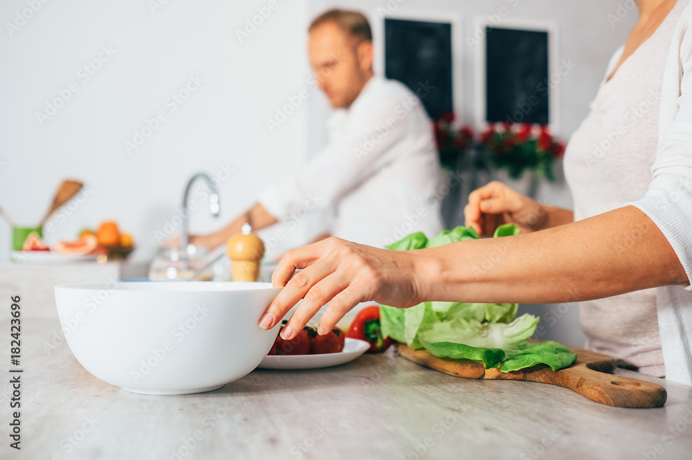 Couple on kitchen cooks together