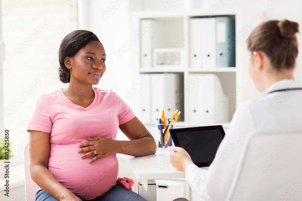 © Syda Productions - doctor with tablet pc and pregnant woman at clinic