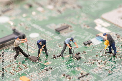 miniature people repair cpu board,teamwork and technology concept photo