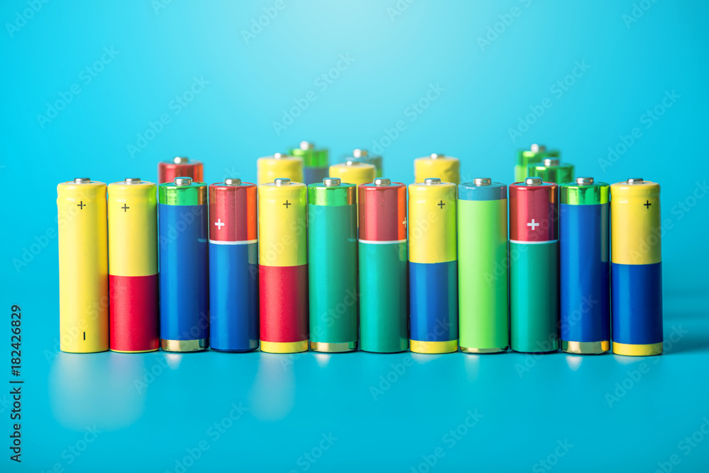 Closeup of a pile of color used alkaline AA batteries. Concept recycling of harmful substances for ecology Closeup of a pile of color used alkaline AA batteries. Concept recycling of harmful substances for ecology