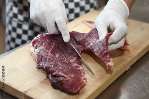 The chef of the restaurant prepares meat horse meat for making sausage-Kazi.Uzbek cuisine.