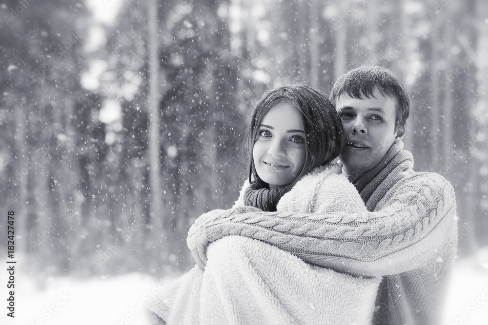 A loving couple on a winter walk. Man and woman on a date in the A loving couple on a winter walk. Man and woman on a date in the