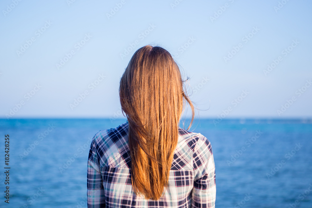 Young girl on blue sea background. Tropical country Young girl on blue sea background. Tropical country