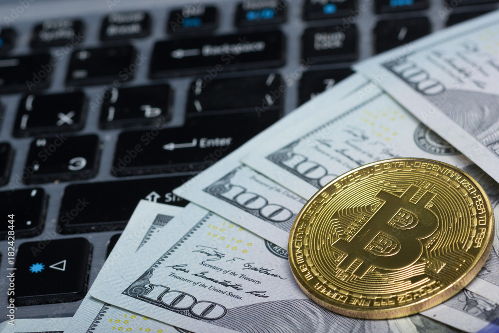 Bitcoin golden coin New virtual money and dollar background . Cryptocurrency. Business and Trading concept. Close-up shot Bitcoin golden coin New virtual money and dollar background . Cryptocurrency. Business and Trading concept. Close-up shot