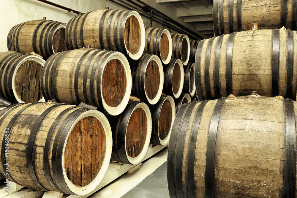 Wooden barrels with wine in cellar