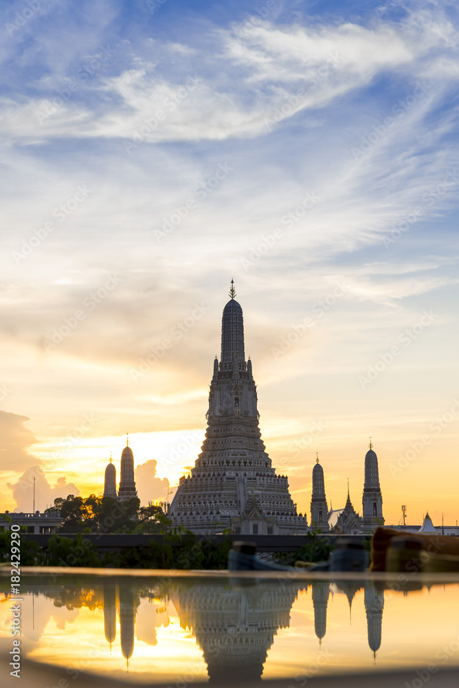 Sunset Wat Arun (Temple of Dawn) and Reflections of Wat Arun Pagoda on glass table is landmark of Attractions's Popular tourists, in bangkok Thailand